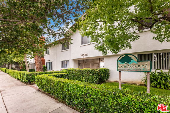 Front view of a two-story condominium building with a sign reading 'Collinwood Condominiums'.