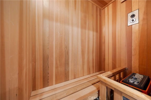 Interior view of a wooden sauna room with heater.