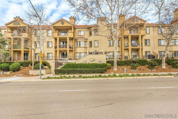 Front view of a multi-story residential building with balconies.