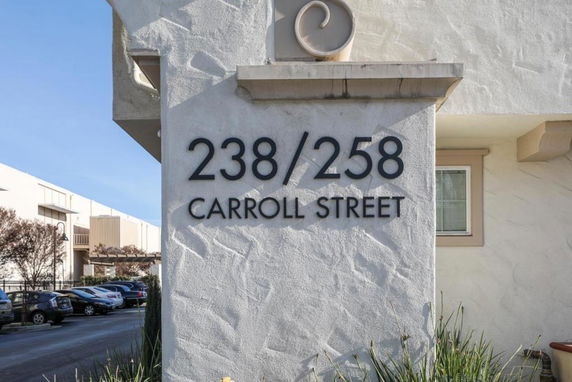Front view of a building with address numbers and street name.