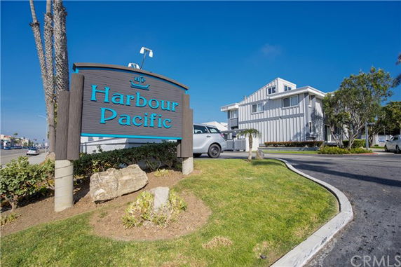Front view of a multi-story building with a sign reading 'Harbour Pacific'.