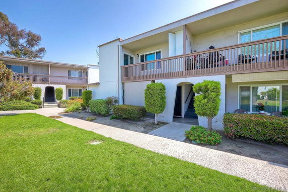 Front view of a two-story apartment building with balconies.