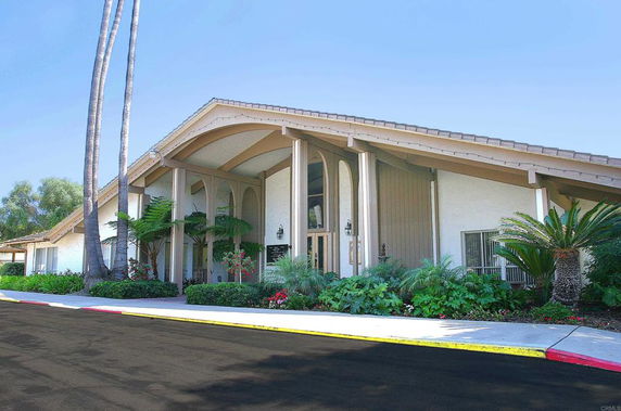 Front view of a building with a sloped roof and large pillars.