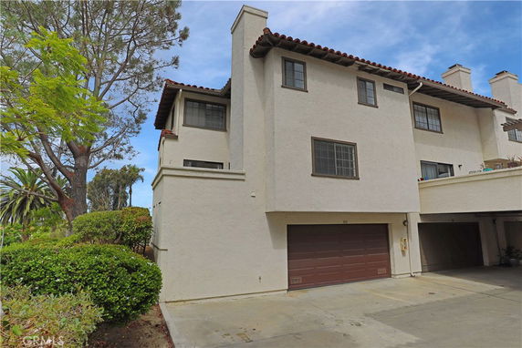 Front view of a multi-story house with a double garage.