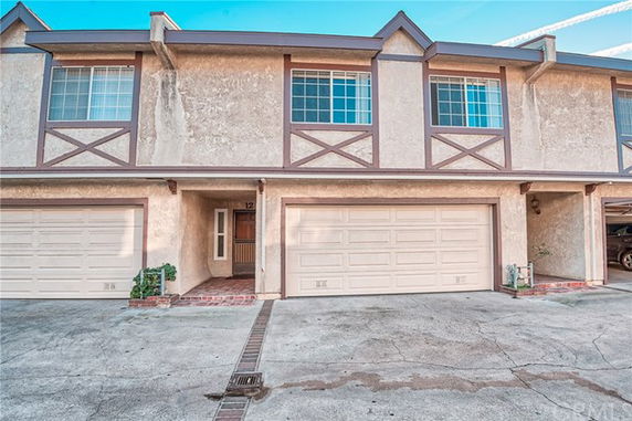 Front view of a two-story townhouse with two garages.