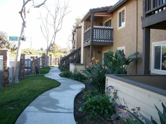 Front view of a two-story apartment building with balconies.