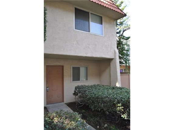 Front view of a two-story house with a small porch area.