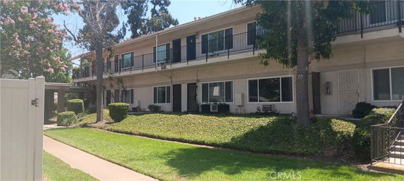 Front view of a two-story residential building with balconies.