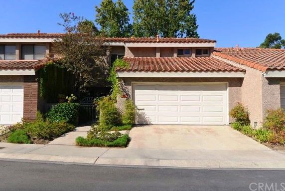 Front view of a two-story house with a tiled roof and a two-car garage.
