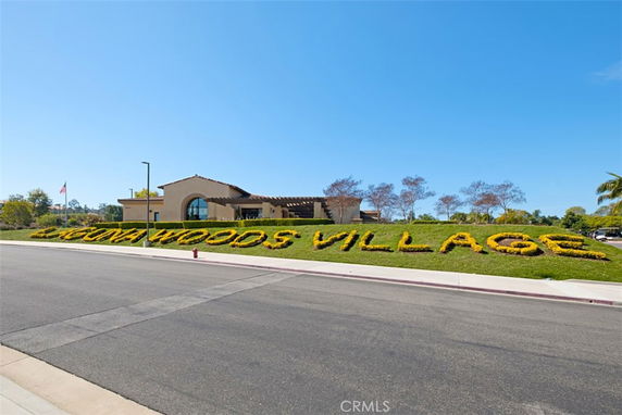 Front view of a single-story building with a large sign displaying 'Laguna Woods Village'.