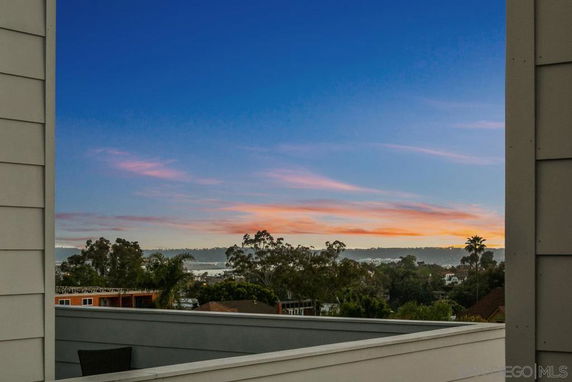 Panoramic view from a building showing a scenic landscape at sunset.
