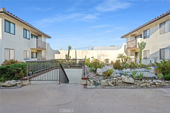 Front view of a two-story residential building with balconies.