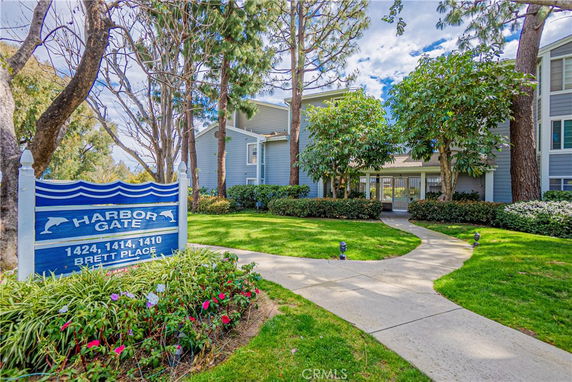 Front view of a multi-story residential building with a walkway leading to the entrance.