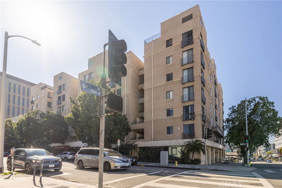 Front view of a multi-story building at an intersection.