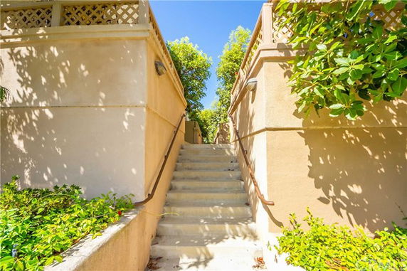 Front view of a stairway leading up between building structures.