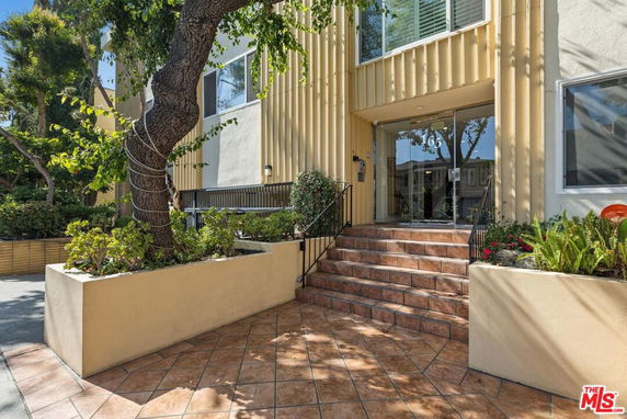 Front view of a multi-story building with a staircase entrance.