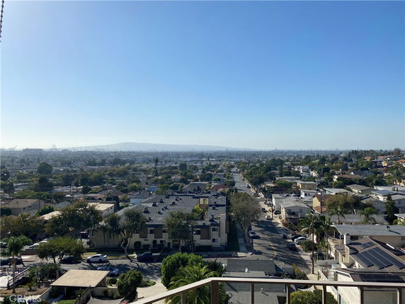 Wide-angle view of a suburban area with buildings and roads extending toward the horizon.