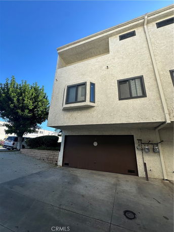 Front view of a multi-story building with a garage.