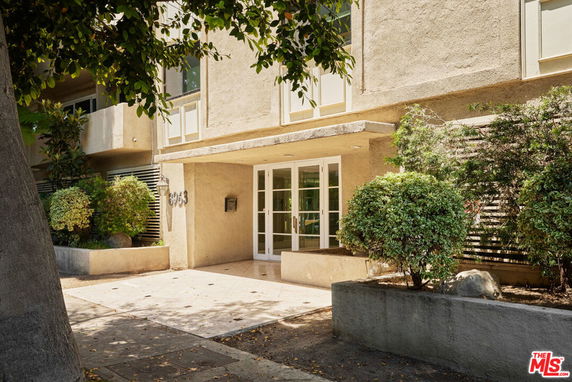 Front view of a building entrance with glass doors.