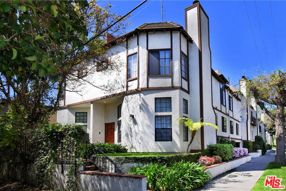 Front view of a two-story house with Tudor-style architecture.