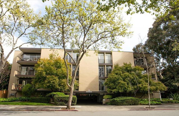 Front view of a multi-story residential building with balconies.