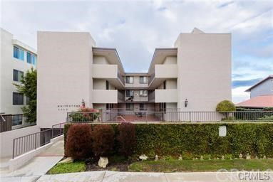 Front view of a multi-story building with modern architecture.