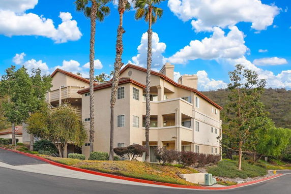 Front view of a multi-story residential building with balconies.