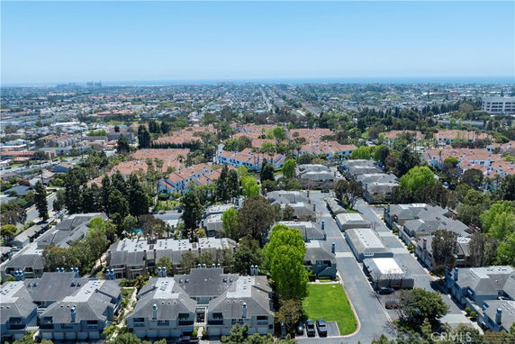 Panoramic view of a residential area with multiple buildings and tree-lined streets.