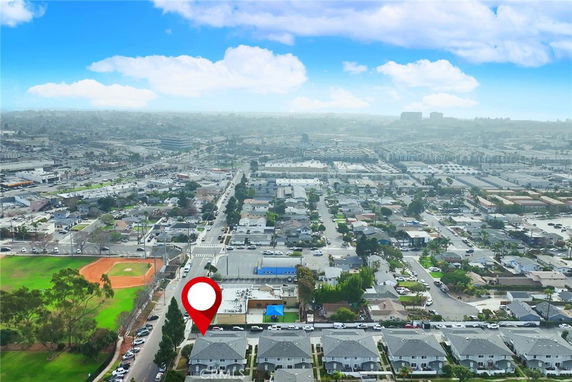 Wide aerial view of a residential and urban area with numerous houses and buildings.