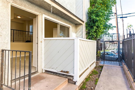 Front view of a building entrance with a small outdoor patio area.