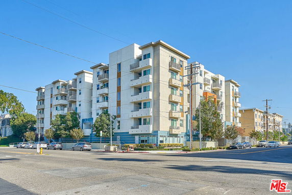 Front view of a multi-story residential building with balconies.