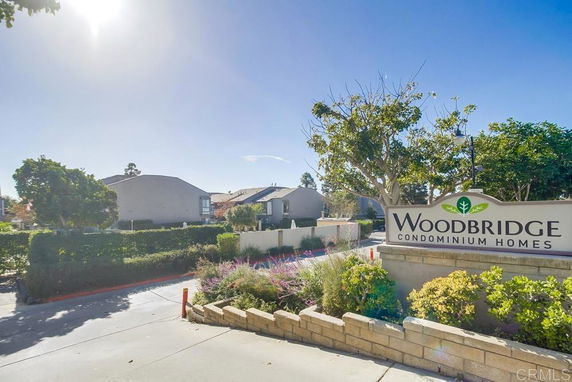 Front view of Woodbridge Condominium Homes with a prominent sign.
