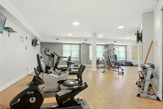 Gym area with exercise equipment and weights.