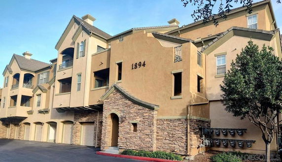 Front view of a multi-story residential building with garages.