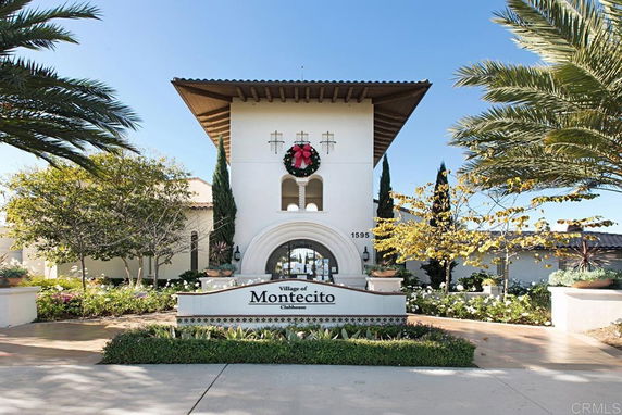 Front view of a building with a large entrance tower and a tile roof.