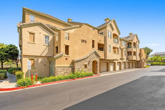 Front view of a multi-story residential building with attached garages.