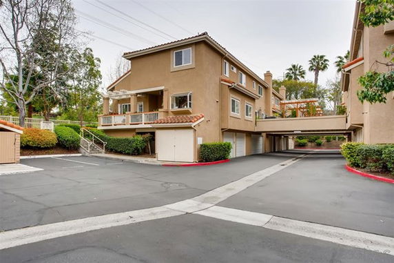 Front view of a multi-story apartment building with a connected walkway.