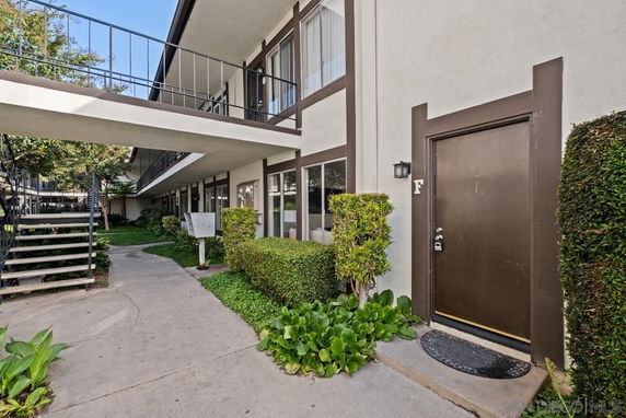 Front view of a multi-level apartment building entrance.