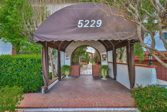 Front view of a building entrance with a canopy and gate.