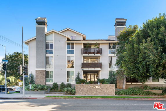 Front view of a multi-story residential building with balconies.