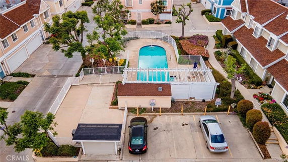 Outdoor view featuring a swimming pool surrounded by residential buildings.