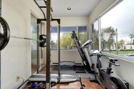 Interior view of a workout area with gym equipment including a treadmill and exercise bike.