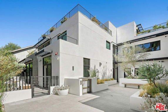 Front view of a modern multi-story building with clean lines and a minimalist design.