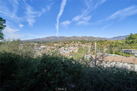 Panoramic view of a suburban area with mountains in the background.