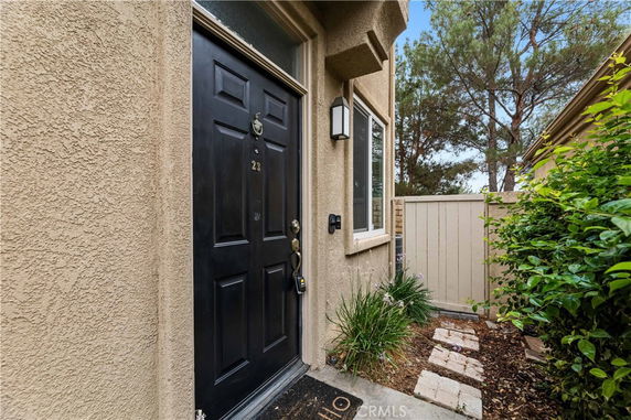 Front view of a house entrance with a black door and small porch area.