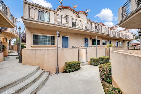 Front view of a multi-story residential building with balconies.