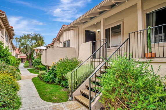 Front view of a house with steps leading to the entrance.