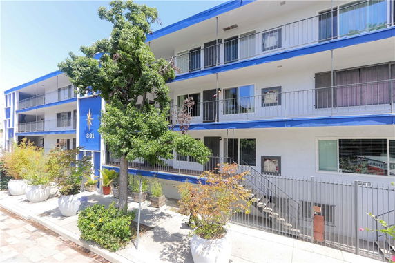 Front view of a multi-story apartment building with balconies.