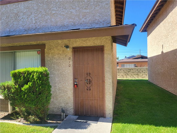 Front view of a house with a metal security door.