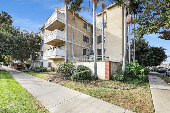 Front view of a multi-story residential building with balconies.